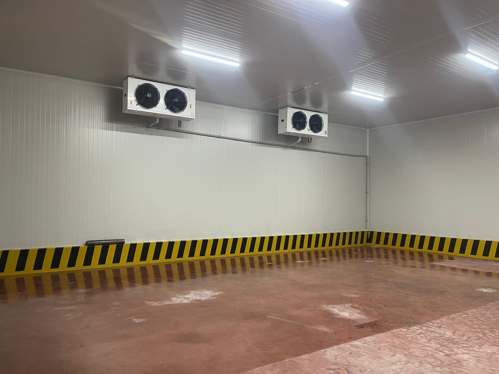 A panel-lined room with overhead cooling units. The equipment family is not identified.