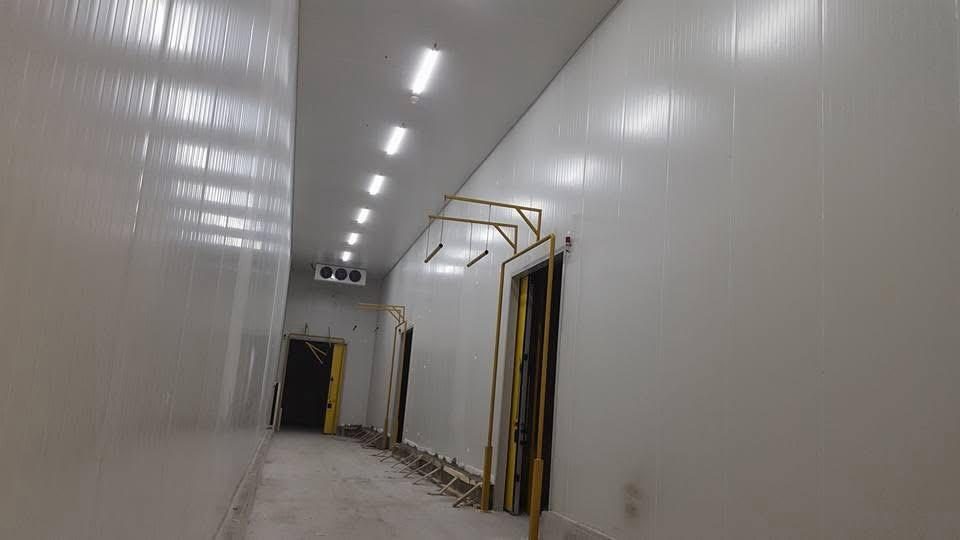 A panel-lined room with overhead rails. The rails are not a catalog product.