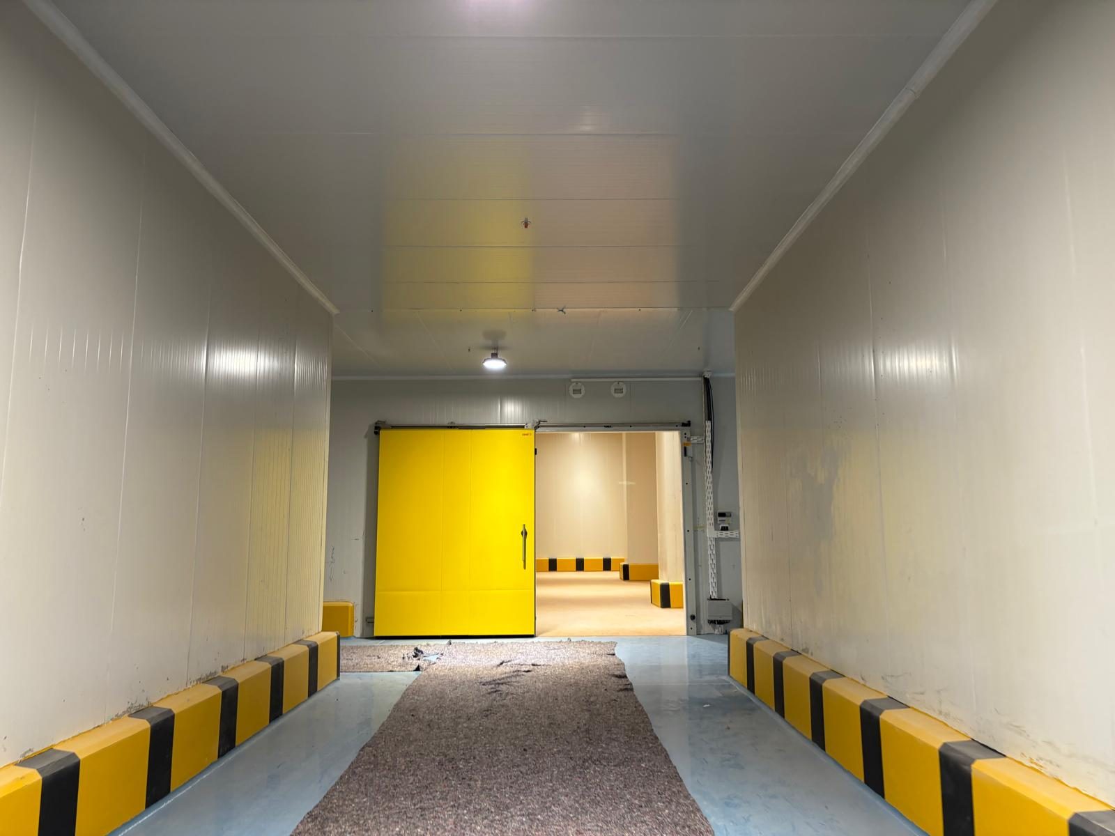 Corridor and entrance views with panel lining.